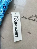 Original factory clearance brand labels attached to brand new pristine women clothing