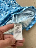 Fabric composition and gentle washing instructions label on ladies summer apparel