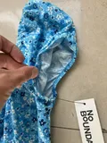 Close-up of the delicate ditsy floral pattern and premium stitching on women dress