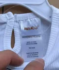 Close-up of baby girl tutu romper care label with size 6-9M and fabric details