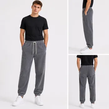 Model wearing men's corduroy jogger pants with drawstring waist, front view