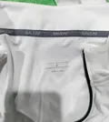 Close-up of reflective chevron logo on back neckline of cycling jersey