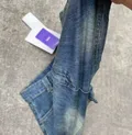 Close-up of rolled cuff hem detail on denim shorts