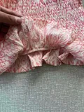 Close-up of the smocked fabric and tie-dye pattern on the girls top