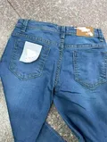 Back view of casual vintage style youth straight leg trousers showcasing seamless pockets placement