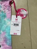 Authentic factory clearance Justice brand clothing tag and retail price barcode sticker attached to brand new youth clothing