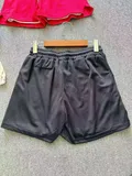 Detail of men's double-layer shorts hem showing breathable outer shell and inner compression liner