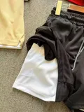 Double-layer athletic shorts showing inner white lining and black mesh outer for sweatpants shorts wholesale