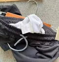 Care label showing 95% cotton 5% linen composition on men's athletic shorts wholesale stock lot