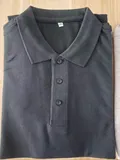 Men's light gray cotton blend polo shirt with tags showing three-button placket and ribbed cuffs for wholesale