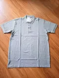 Men's polo shirt collar and shoulder detail with 2XL size label and pique knit texture for bulk inventory