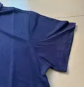 Short sleeve detail of men's cotton-spandex polo shirt showing ribbed cuff and pique knit texture