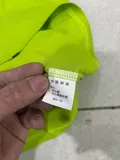 Care label showing 80% cotton 20% polyester fabric composition on men's tipped polo shirt bulk inventory