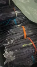 Dark tipped polo shirts individually poly-bagged and bundled with color-coded straps for bulk shipping