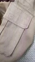 Close-up of secure heavy-duty flap cargo side pocket with reinforced stitching on men's stretch twill work shorts