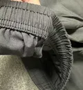Close-up of hem and inseam stitching on men's nylon shorts