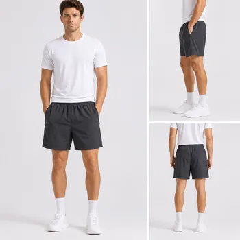 Model wearing men's black nylon quick-dry shorts with zip pockets, front view