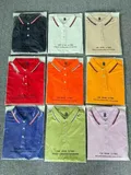Nine color assortment of men's polo shirts in factory packaging for wholesale polo shirts distribution