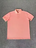 Care label showing 51.9% polyester 48% cotton 1.7% mulberry silk composition on men's polo shirt for bulk resale