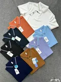 Eight men's striped trim polo shirts fanned out showing multi-color options with contrast tipped collars for wholesale bulk