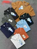 Seven men's polo shirts in navy white black mustard burnt orange sky blue and charcoal with coordinated striped trim for wholesale
