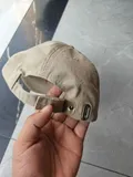 Back view of the washed cotton cap showcasing the heavy-duty adjustable metal buckle strapback closure for universal sizing