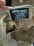 Individual factory-pristine protective polybag packaging containing a neatly folded washed cotton baseball cap with retail upc barcode