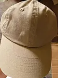 Detailed shot of the precision multi-row stitching on the curved brim and breathable embroidered eyelets of the dad hat