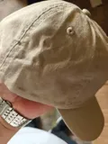 Detailed shot of the precision multi-row stitching on the curved brim and breathable embroidered eyelets of the dad hat