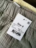 Women's heathered olive green cotton shorts flat lay showing elastic shirred waistband and side pockets for wholesale