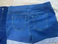 Back view of casual women's short jeans trousers showcasing symmetrical utility pockets placement