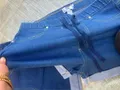 Close-up of flexible ribbed elastic denim waistband with contrast functional dark blue active drawstring