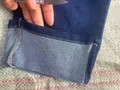 Close-up of flexible ribbed elastic denim waistband with contrast functional dark blue active drawstring