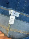 Fabric content and laundering instructions care label inside women's comfort stretch cuffed jeans shorts