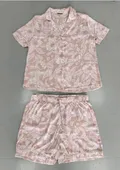 Front view of an elegant model wearing a women's dusty rose floral satin pajamas short sleeve 2-piece set