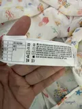 Fabric composition and washing instructions label on ladies tiered resort wear