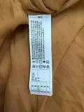 Fabric composition and washing instructions label on ladies heavy-weight tailored knitwear