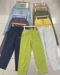 Multi-color assortment of women's straight casual pants hanging display for wholesale buyers