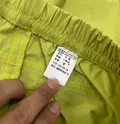 Fabric care label showing 88% polyamide and 12% elastane on women's casual pants wholesale lot