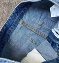 Interior label and stitching detail of women's ripped jeans wholesale lot for boutique and online resale