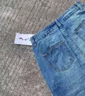 Rear pocket and hem detail of light blue wide-leg jeans wholesale denim stock for distributors
